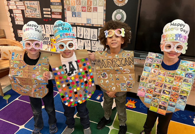 Kindergarten students pose in costumes celebrating 100th day of school