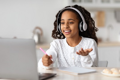 student using a computer with headphones