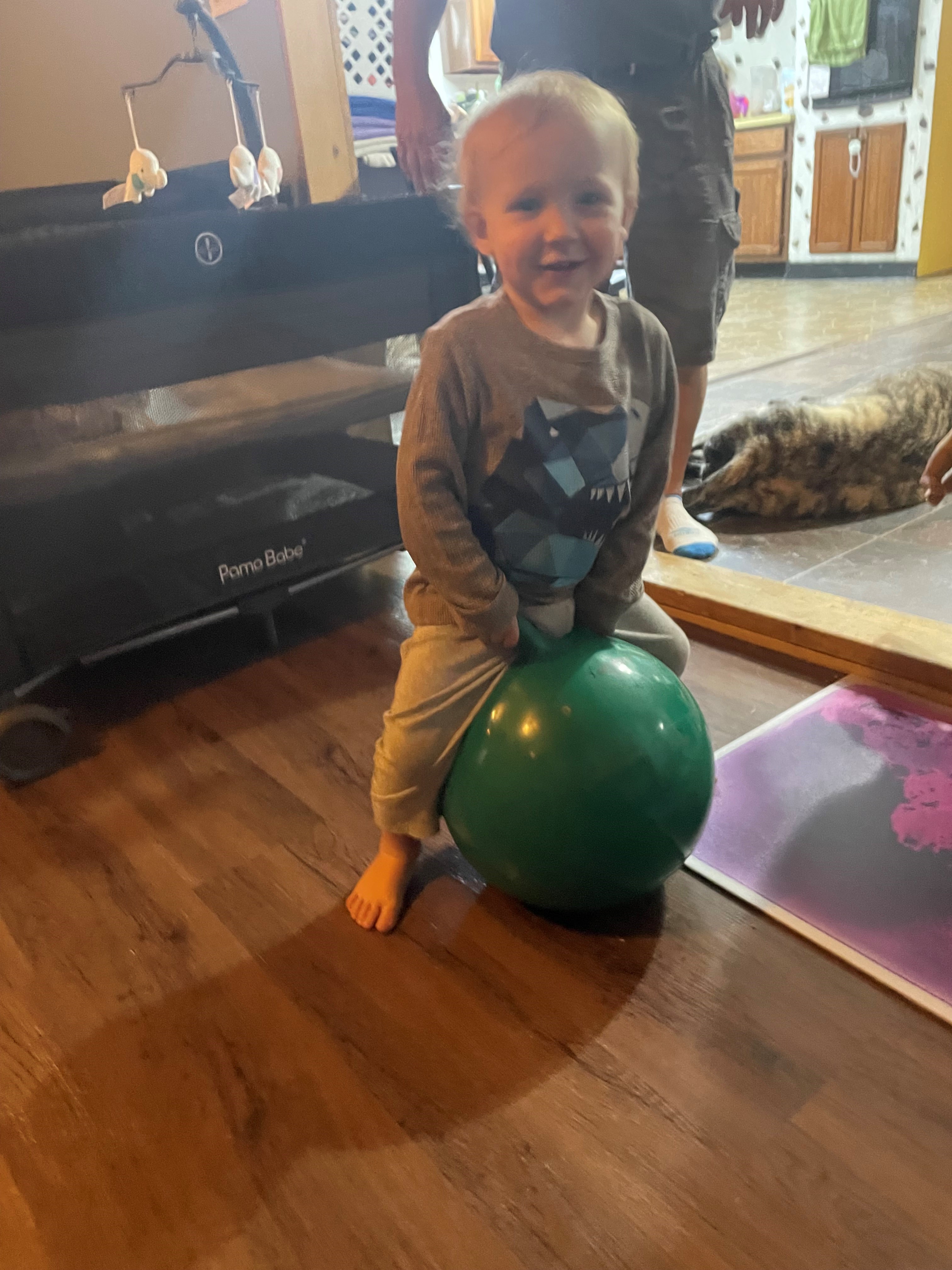 Toddler bouncing on a ball