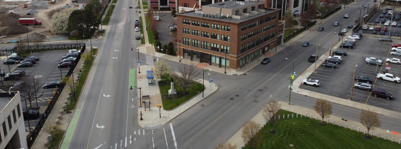 two streets meet and one has cross walks and a bike path