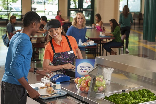 student choosing vegetables at their school cateferia