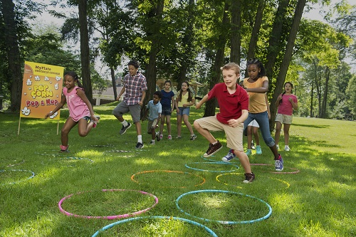 students playing with hula hoops outdoors