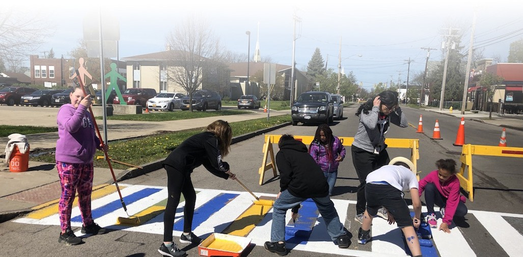 Students painting a crosswalk
