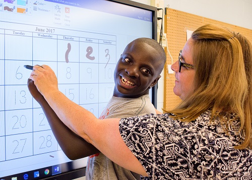 photo of students on a computer